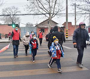 时博（中国）青年文明号义务指挥交通，为学生上学安全保驾护航